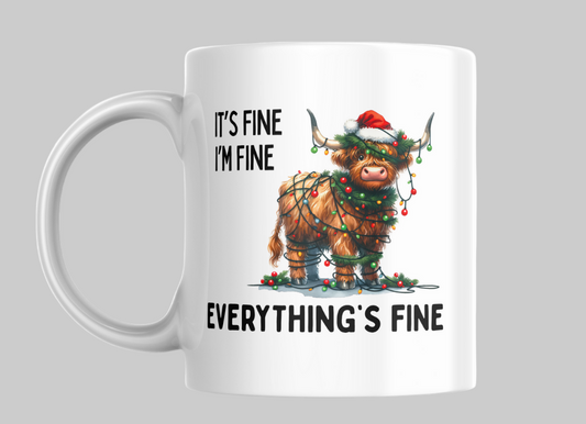 White mug with a cartoon Highland Cow wearing a Santa hat and Christmas lights, text 'It's fine, I'm fine, everything's fine' on a white background.