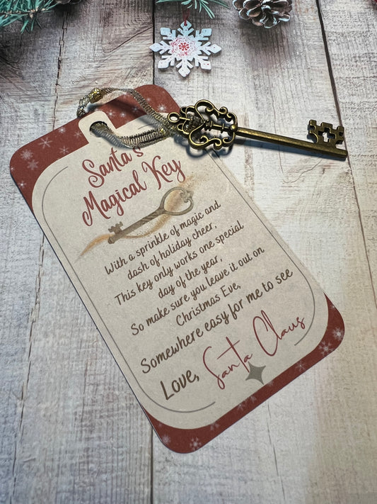Golden metal key attached to red and cream card with the words Santa's Magic Key.