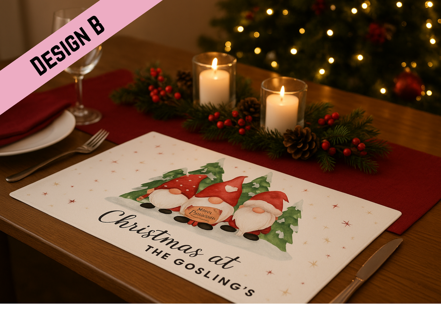 A cozy Christmas dining table set with a placemat featuring three watercolor gnomes in red hats with snowy pine trees in the background. The table is decorated with red napkins, pinecones, holly berries, and lit candles, with a softly glowing Christmas tree behind.