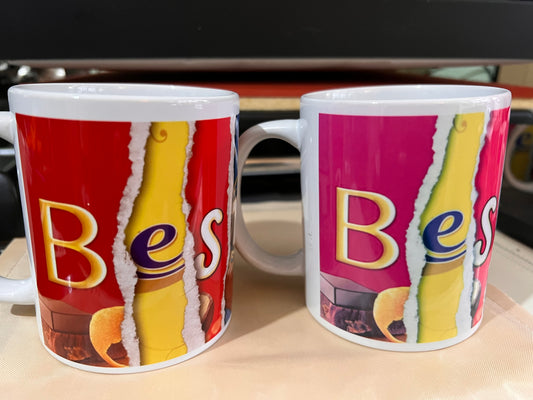 2 (two) mugs containing the words Best Dad which are formed using words from images from chocolate wrappers